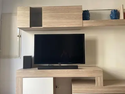 a flat screen tv sitting on top of a wooden table at Dimora Normanna in Palermo