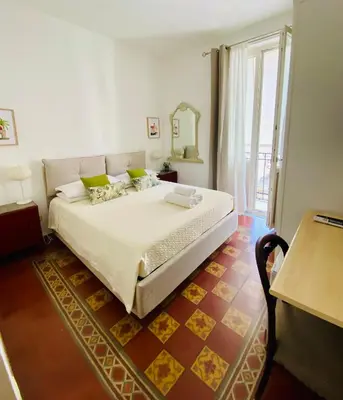 a bedroom with a large bed and a large window at Alvorada Rooms in Palermo