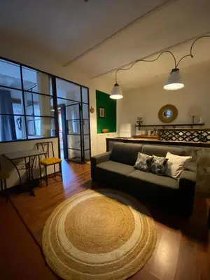 a living room with a couch and a rug at Alvorada Rooms in Palermo