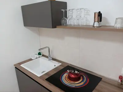 a kitchen with a sink and a plate on a counter at The Junction in Palermo