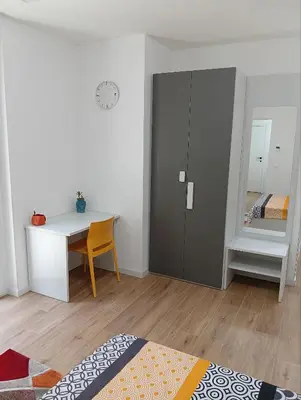 a bedroom with a desk and a bedroom with a bed at The Junction in Palermo