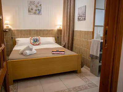 a small bedroom with a bed and a shower at Casa Melina in Palermo
