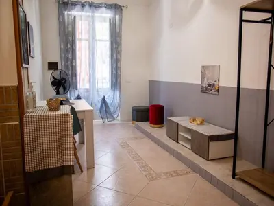a living room with a bench and a table and a window at Casa Melina in Palermo