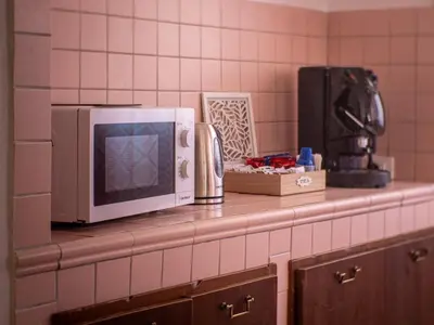 a counter with a microwave on top of it at Casa Melina in Palermo