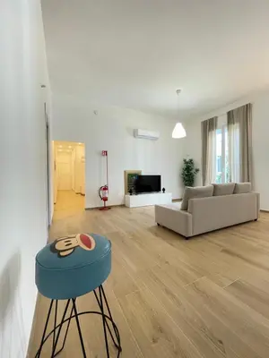 a living room with a blue stool and a couch at Iazzu Apartament in Palermo