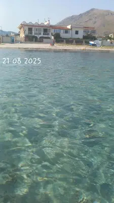 a large body of water with buildings in the background at Le Terrazze sul mare Joelle -The uniqueness of the Terrace overlooking the sea in Carini