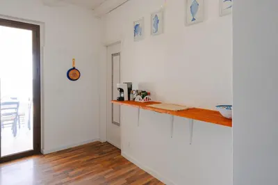a bedroom with a bed and paintings on the wall at Le Terrazze sul mare Joelle -The uniqueness of the Terrace overlooking the sea in Carini