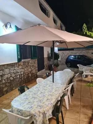 a table with an umbrella on a patio at Ombelico di VenereVilla in Mandra Capreria