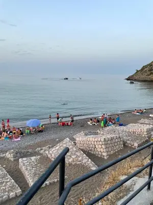 a group of people on a beach with the ocean at Ombelico di VenereVilla in Mandra Capreria