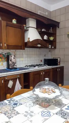 a kitchen with a table with a plate of food on it at Ombelico di VenereVilla in Mandra Capreria