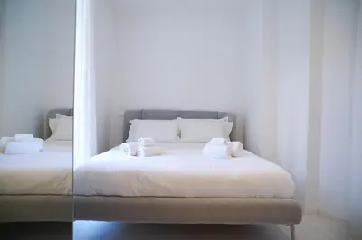 a bedroom with a bed with towels on it at Mama suites Politeama in Palermo