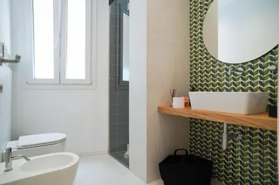 a bathroom with a sink and a mirror at Mama suites Politeama in Palermo