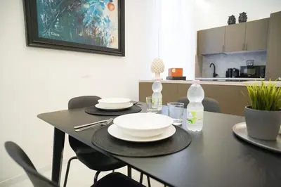 a black table with plates and glasses on it in a kitchen at Mama suites Politeama in Palermo