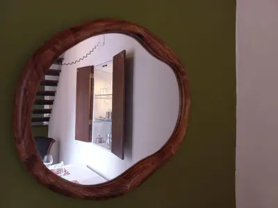 a mirror with a wooden frame on a wall at Ballaria Pop Art in Palermo