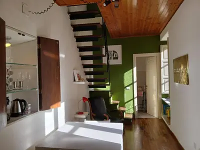 a room with a staircase and a green wall at Ballaria Pop Art in Palermo
