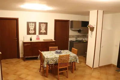 a kitchen and dining room with a table and chairs at Homedaf in Carini