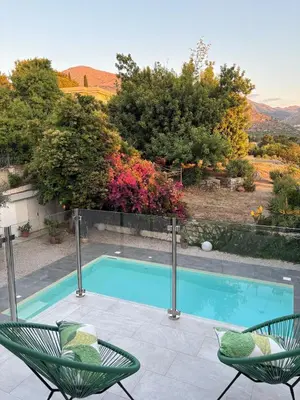 a swimming pool with two chairs next to it at Villa Grasta, Nuova Esclusiva con Piscina in Capaci
