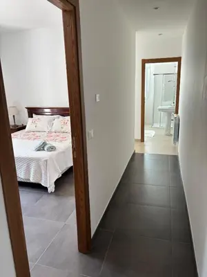 a bedroom with a bed and a hallway with a mirror at Villa Grasta, Nuova Esclusiva con Piscina in Capaci
