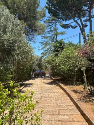 a brick road with a car parked in the distance at Villa Grasta, Nuova Esclusiva con Piscina in Capaci