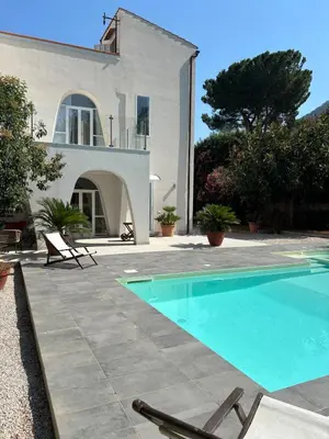 a villa with a swimming pool in front of a house at Villa Grasta, Nuova Esclusiva con Piscina in Capaci