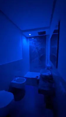 a blue room with two toilets and a window at Mondello D'Amare in Palermo