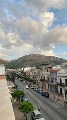 a city street with cars parked on the road at Ma Home in Cinisi