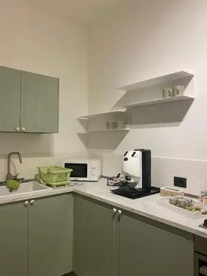 a kitchen with green cabinets and a white counter top at Ma Home in Cinisi