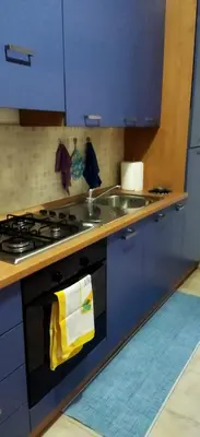 a kitchen with a stove and a sink with a yellow towel at A 2 passi dal Politeama in Palermo