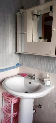 a bathroom with a white sink and a mirror at A 2 passi dal Politeama in Palermo
