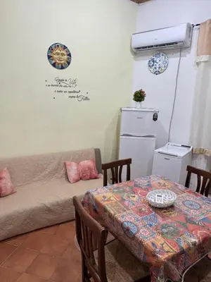 a living room with a table and a couch at Casa la Fenice in Palermo