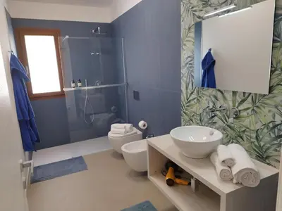 a bathroom with a toilet and a sink and a shower at La Marina Pool Villa in Trappeto