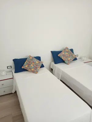 a small bedroom with a bed and a table at Butterfly Apartments in Palermo