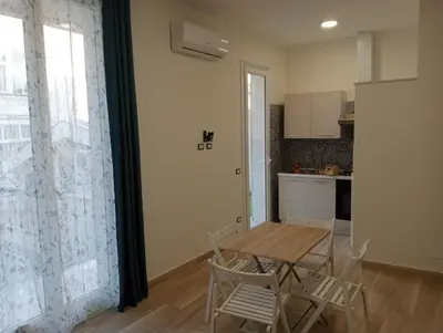 a dining room with a table with chairs and a television at Butterfly Apartments in Palermo