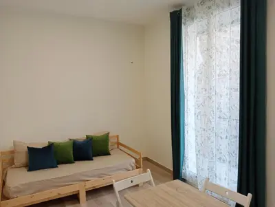 a room with a bed and a window with a couch at Butterfly Apartments in Palermo