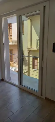 a sliding glass door with a view of a balcony at Studio 23 in Partinico