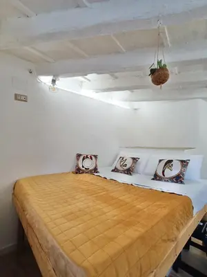 a bedroom with a bed in a white room at Il Pirtuso in Palermo