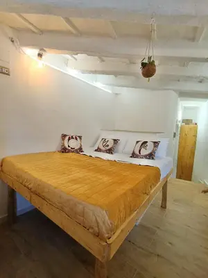 a bedroom with a wooden bed in a room at Il Pirtuso in Palermo