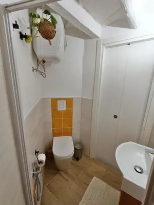 a small bathroom with a toilet and a sink at Il Pirtuso in Palermo