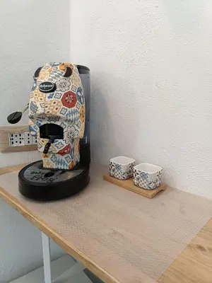 a coffee maker sitting on a table with two cups at Il Pirtuso in Palermo