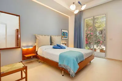 a bedroom with a bed and a large window at Villa Marinjo in Alcamo