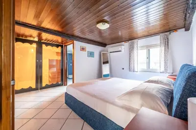 a bedroom with a large bed with a wooden ceiling at A casa di GIO&GRACE in Palermo