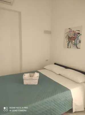 a bedroom with a bed with a basket on it at Summer House in Isola delle Femmine