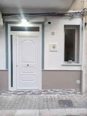 a white door on the side of a building at Summer House in Isola delle Femmine