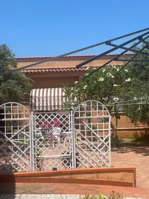 a white gate in front of a house at Villa Fiory in Terrasini