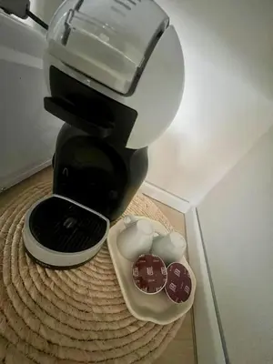 a black coffee maker sitting on top of a table at Casa TreMar - Flat with roof top in Mondello in Palermo