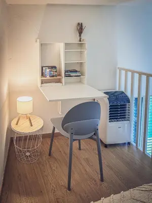 a desk and a chair in a room at Casa TreMar - Flat with roof top in Mondello in Palermo