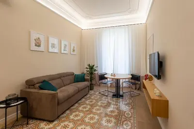a living room with a couch and a table at Suite80 in Palermo