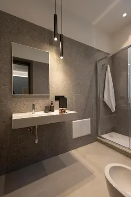 a bathroom with a sink and a mirror and a shower at Suite80 in Palermo