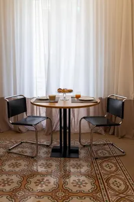 a table and two chairs in front of a window at Suite80 in Palermo