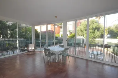 a room with a table and chairs on a balcony at Villa Cetti a Mondello in Palermo